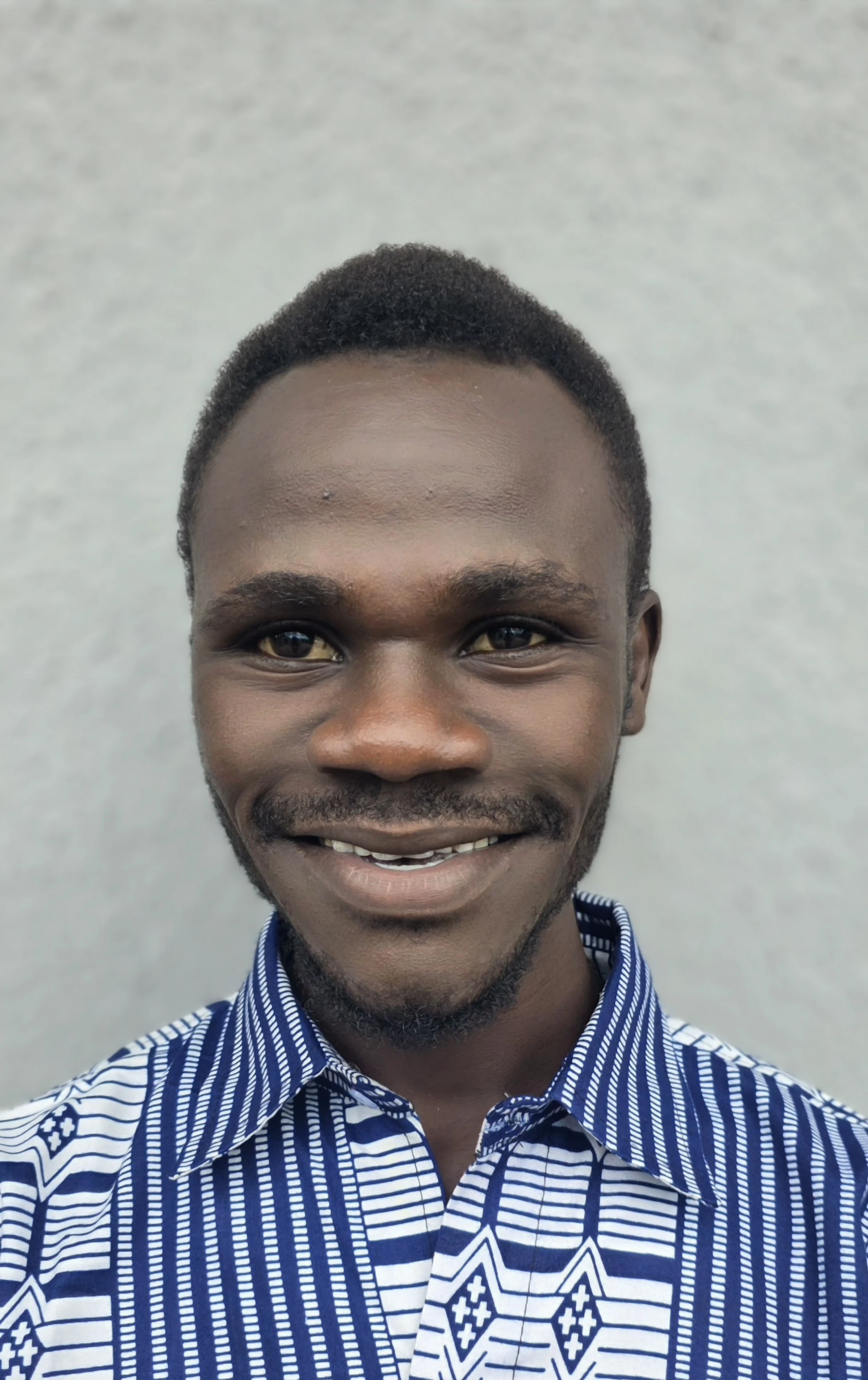 A student smiling after graduating from ECU
